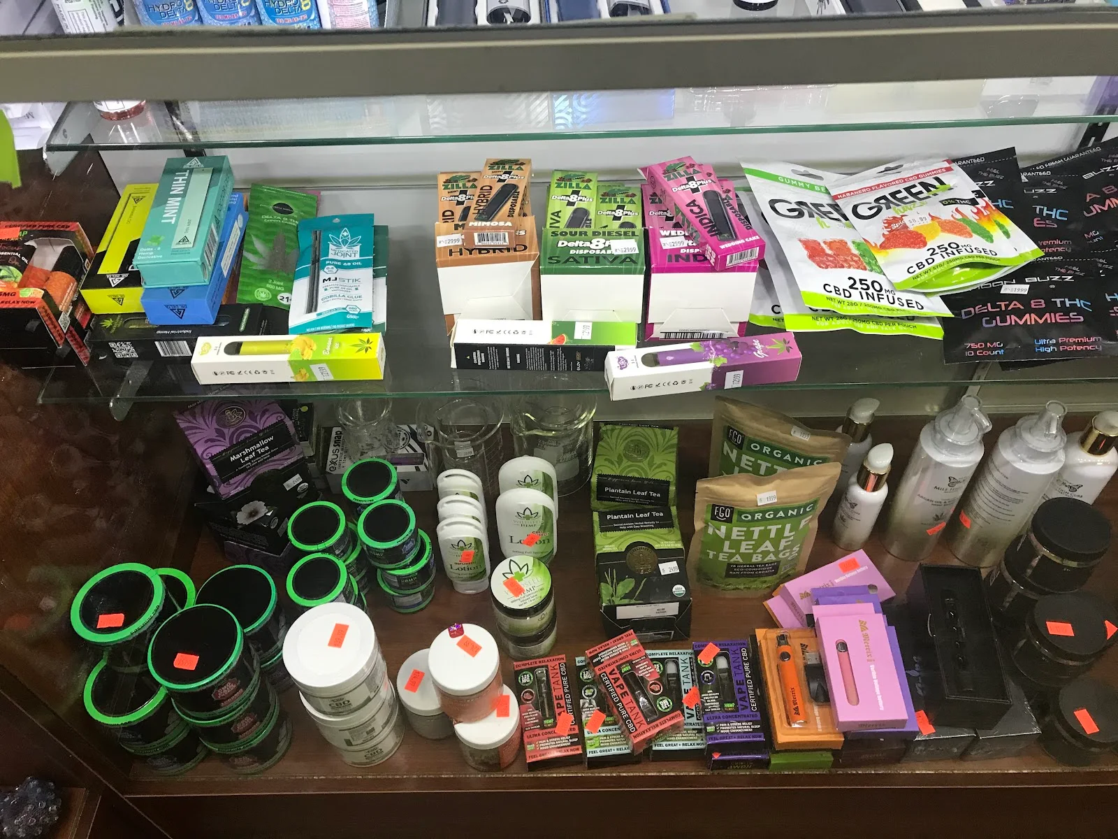 Glass counter case holding CBD gummies, tinctures, lotions and herbal teas