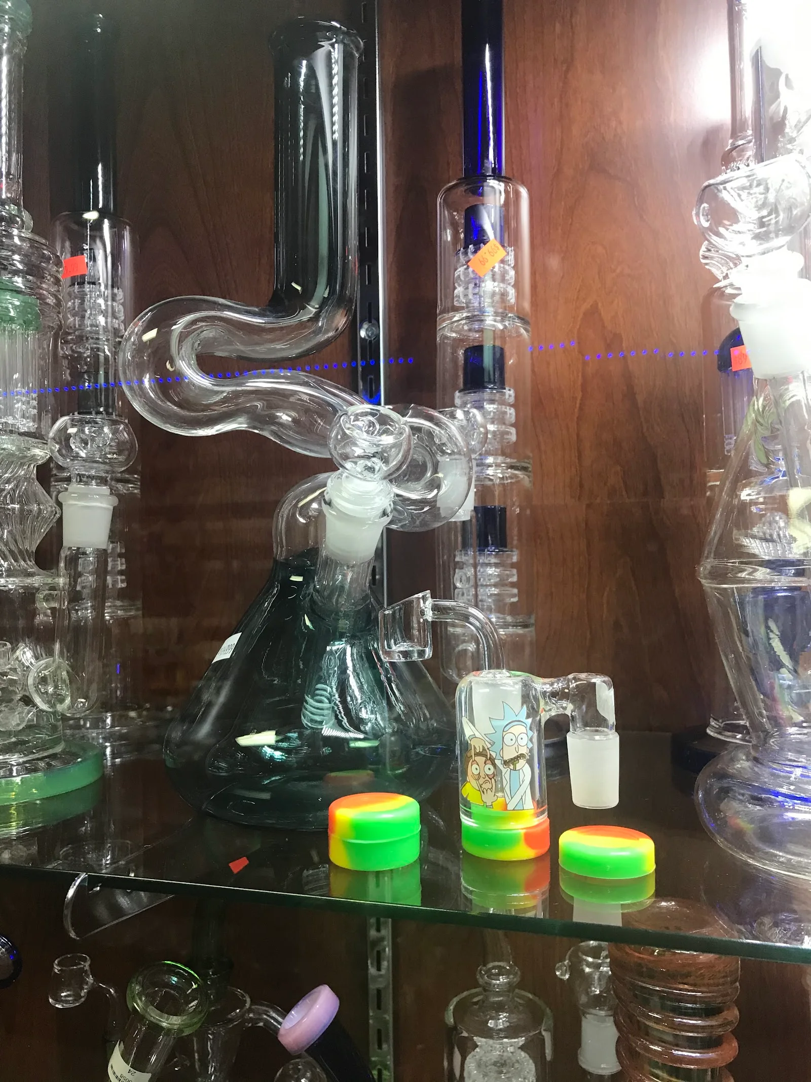 Close-up of clear glass rigs, a quartz banger and silicone jars